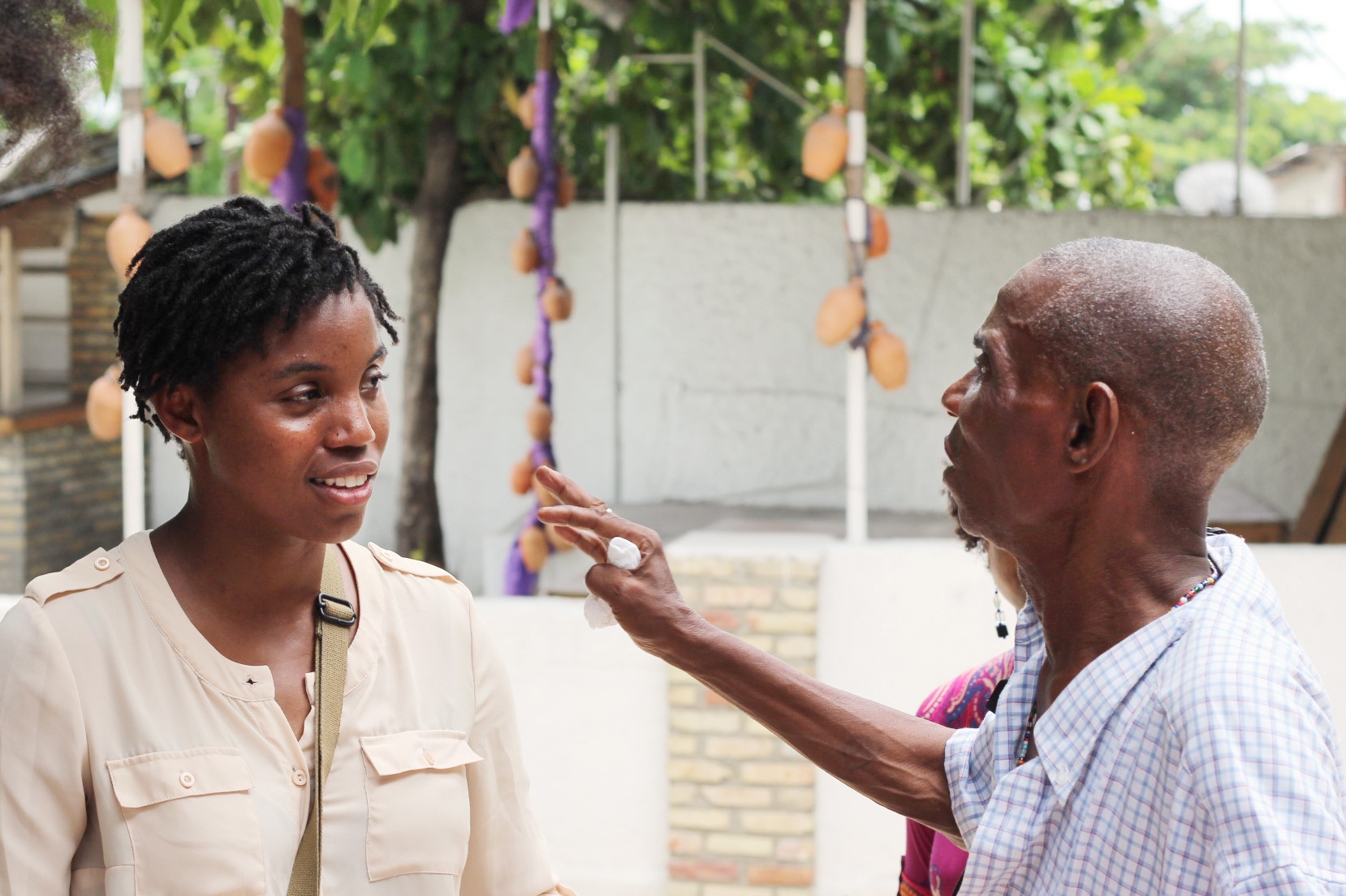 Student learning from elder in Haiti